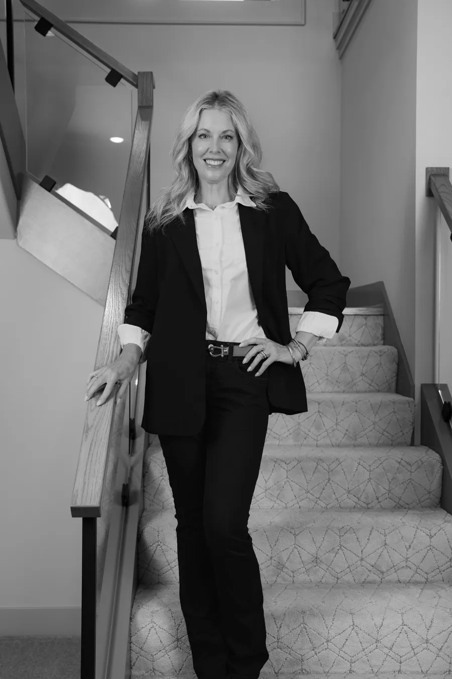 Black and white portrait of Cara Painter on a staircase